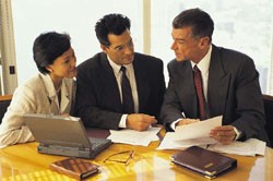 3 individuals looking over files